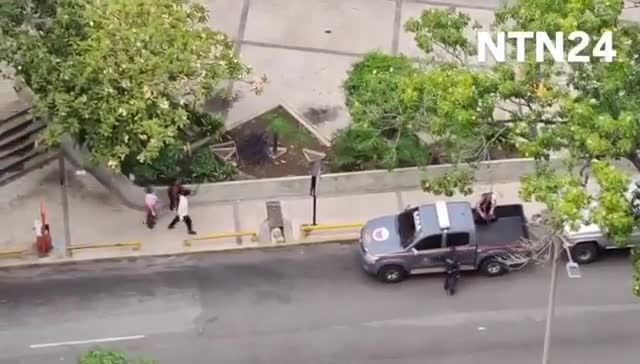 Police agents take journalist Carmela Longo and her son from their home in Caracas